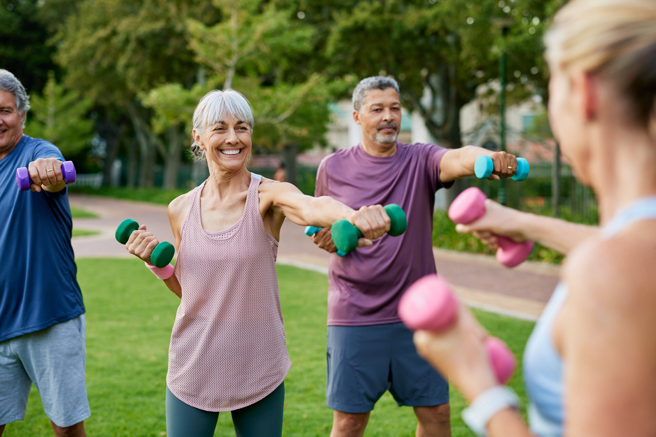 A group of people lifting weights.